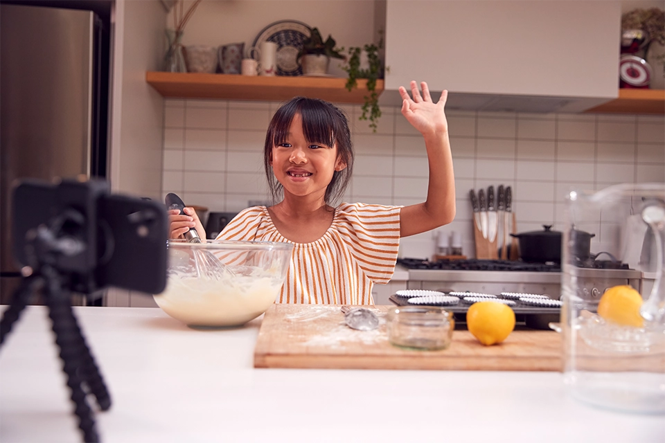 Kid influencer filming herself baking