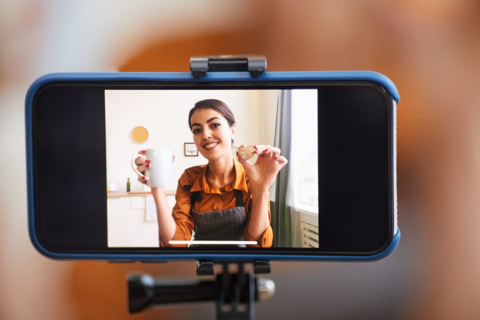 Woman filming herself on a smartphone