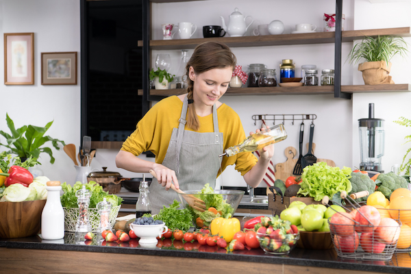 health food influencer cooking in kitchen surrounded by ingredients