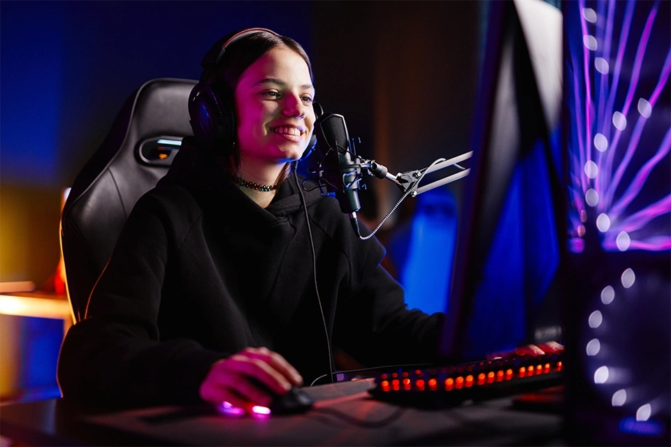 Female Twitch streamer smiling next to a mic