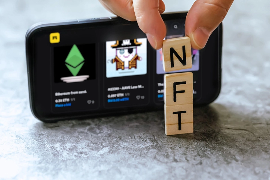 NFT examples on a cell phone marketers might use for NFT influencer marketing