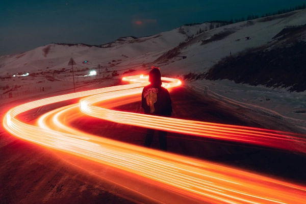 A person standing in a long exposure light photo demonstrating the need of staying innovative in influencer marketing to create something interesting