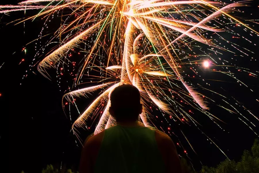 man watching fireworks after brand uses experiential marketing with influencers