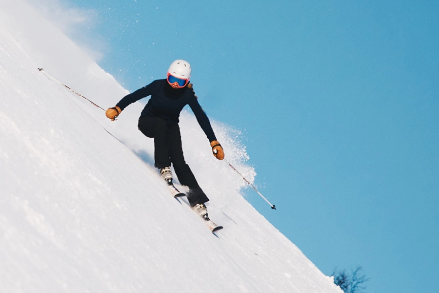 person skiing downhill for seasonal brand ads