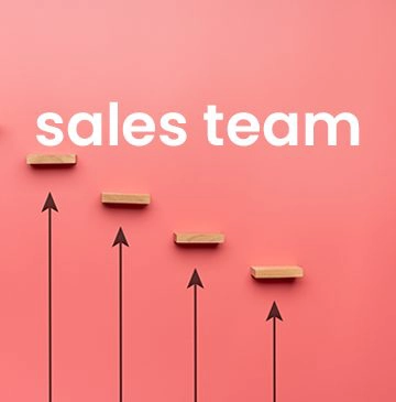 sales team words above four descending wooden blocks above arrows pointing up