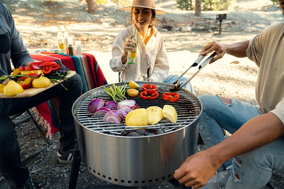 Outdoor influencers cooking on a firepit