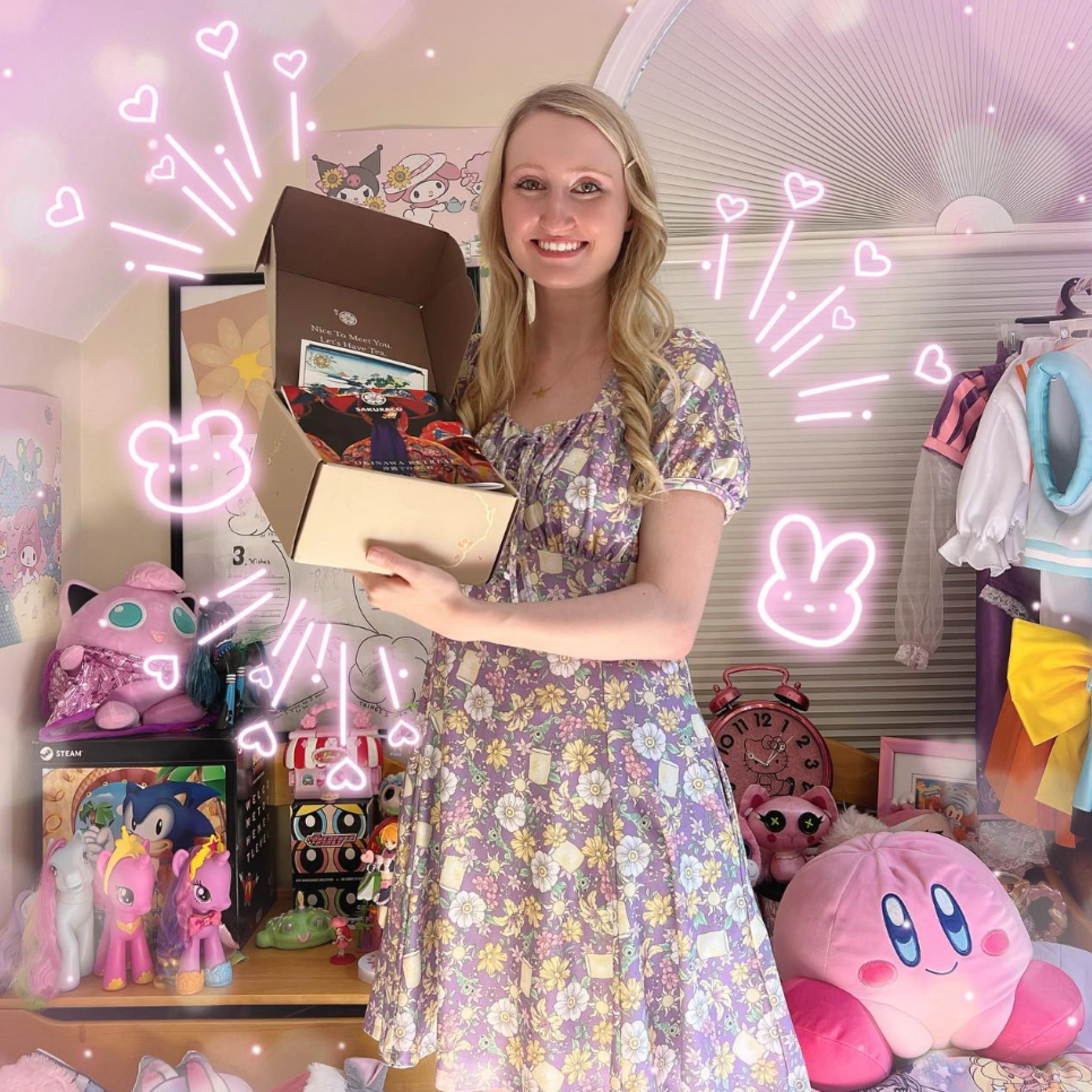 Woman holding an open TokyoTreat box in front of many plushies in her room