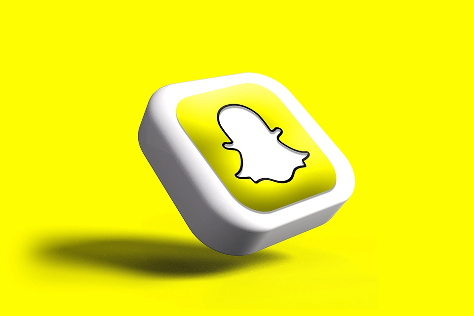 3D Snapchat logo at an angle against a yellow background symbolizing Snapchat influencer marketing