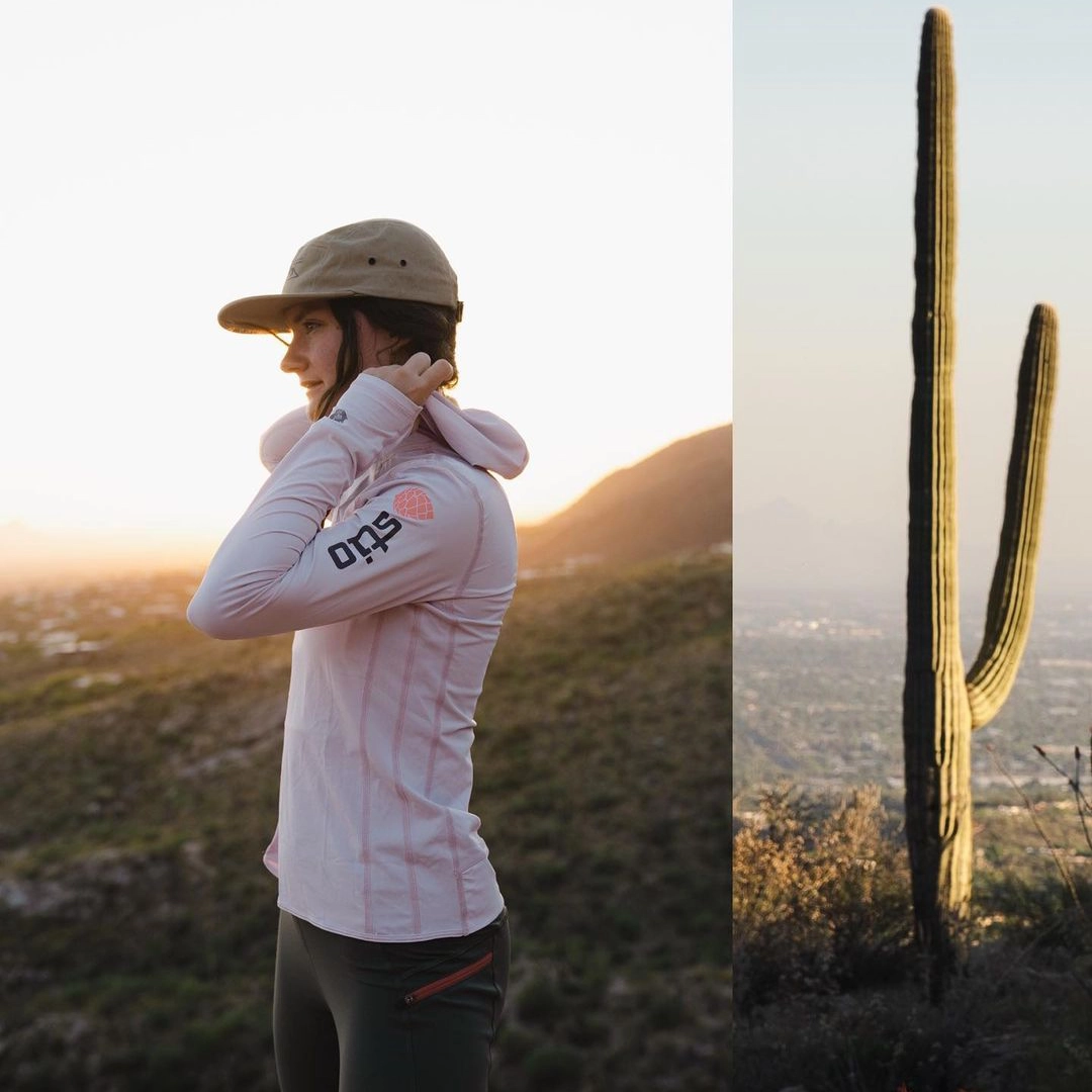 A person in a Stio shirt in a desert next to a large cactus