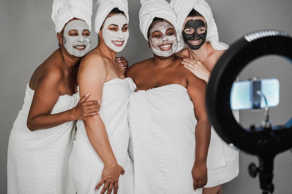 women at a spa standing in front of a photo light indicating hiring a photographer is a good spa marketing idea