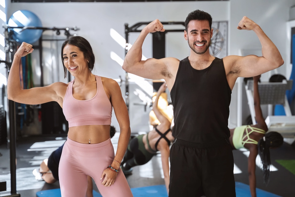 Two fitness influencers flexing