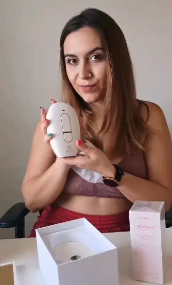 a woman holding up a RoseSkinCo. hair removal product