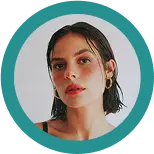 Headshot of a woman with long hair in an orange circle